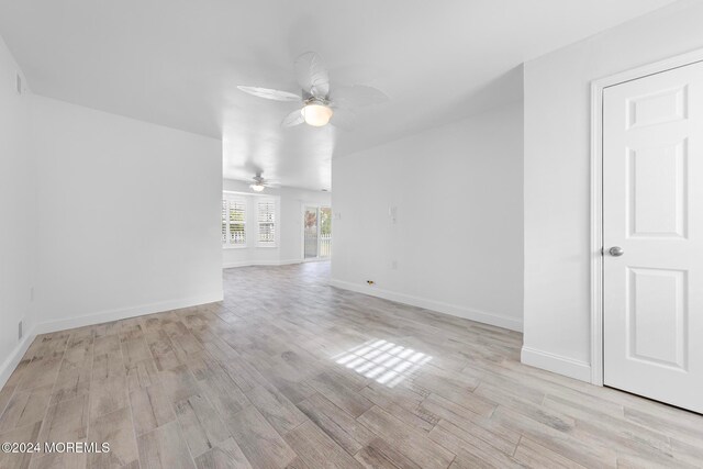 unfurnished living room with ceiling fan and light hardwood / wood-style flooring