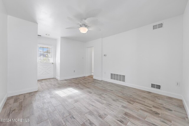 unfurnished room with ceiling fan and light wood-type flooring