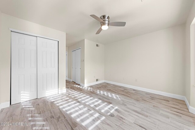 unfurnished bedroom with ceiling fan and light hardwood / wood-style flooring