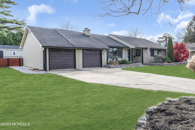 ranch-style home with a front yard and a garage