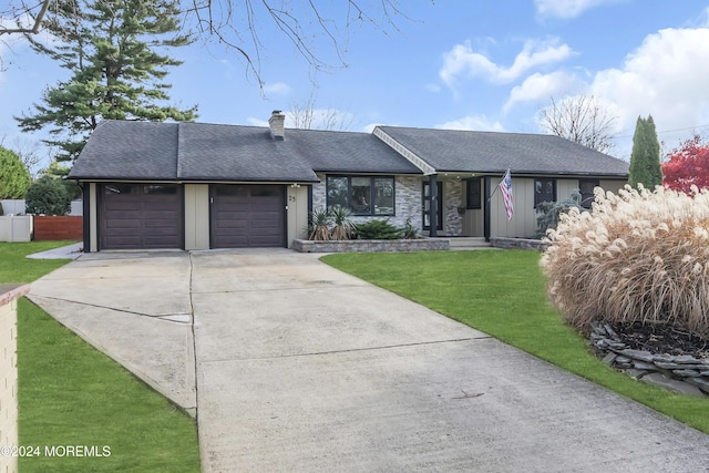 ranch-style home with a garage and a front yard