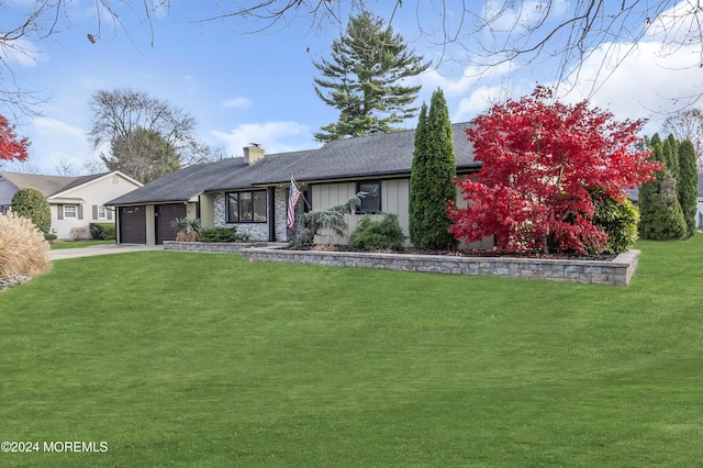 ranch-style home with a front yard and a garage