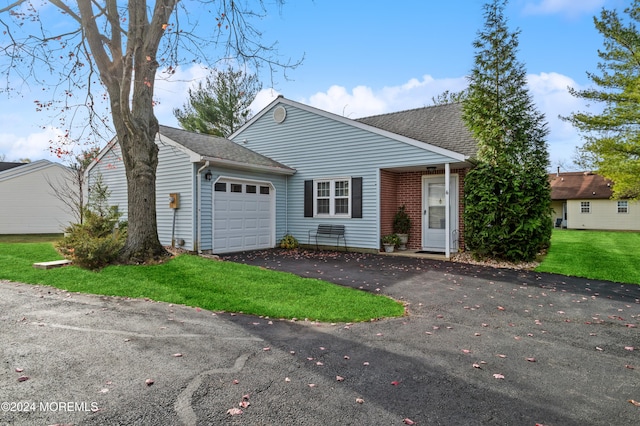 view of front of property with a garage and a front yard