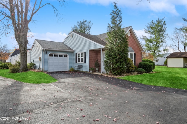 view of front of home with a garage and a front lawn