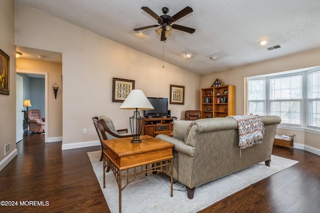 living room featuring a textured ceiling, vaulted ceiling, ceiling fan, and dark wood-type flooring