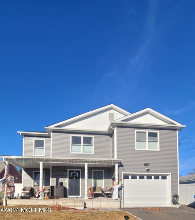 view of front facade featuring covered porch and a garage