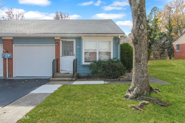 view of front of home with a garage and a front lawn