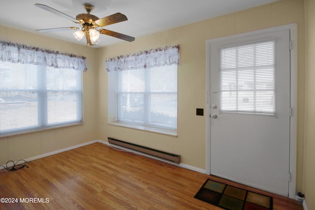 entryway with wood-type flooring, plenty of natural light, and baseboard heating