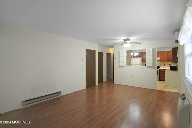 unfurnished living room featuring radiator heating unit, light hardwood / wood-style flooring, baseboard heating, and ceiling fan