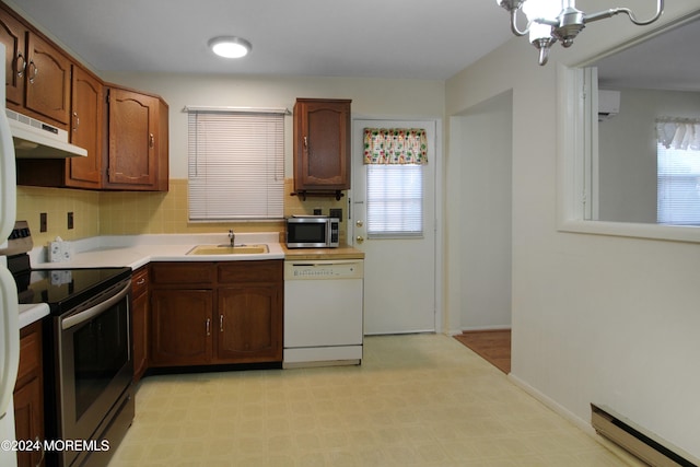 kitchen featuring appliances with stainless steel finishes, a baseboard radiator, extractor fan, and a wealth of natural light