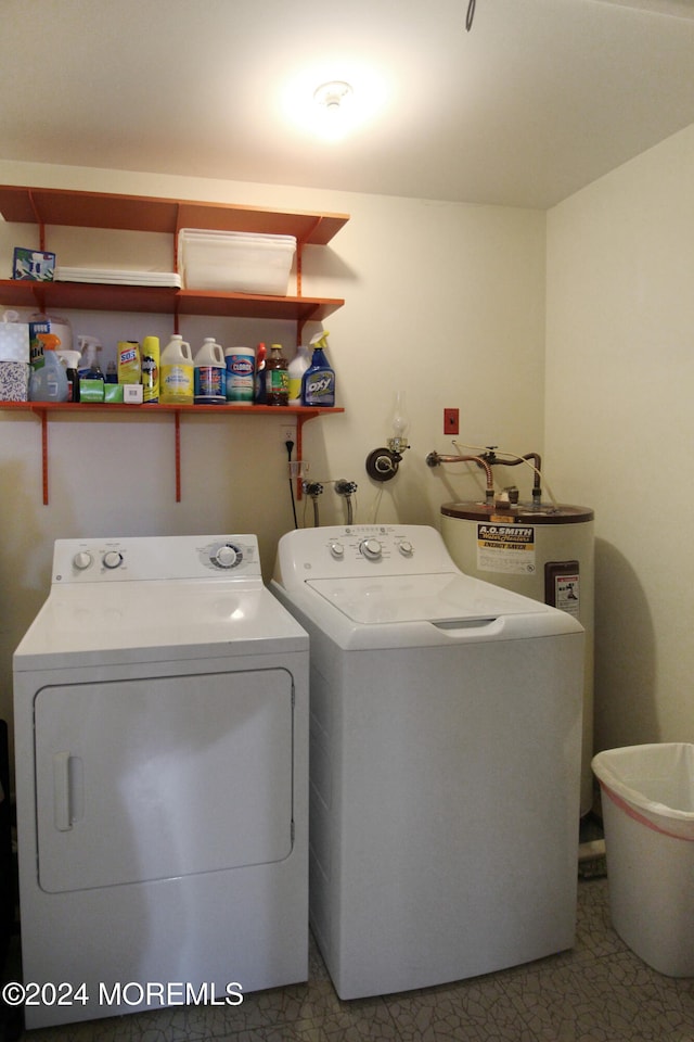 laundry room with water heater and washer and dryer