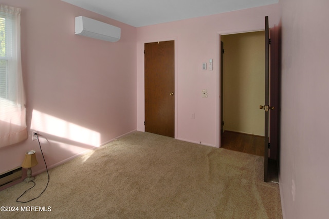 unfurnished bedroom with carpet flooring, an AC wall unit, and a baseboard radiator