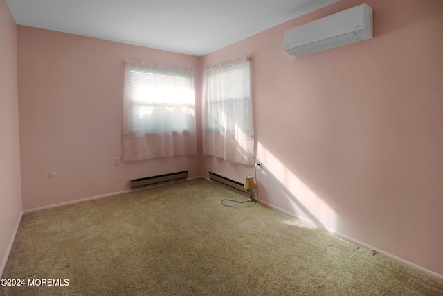 spare room with light colored carpet, a wall unit AC, and a baseboard heating unit