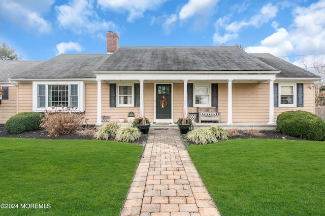 view of front of house with a porch and a front yard