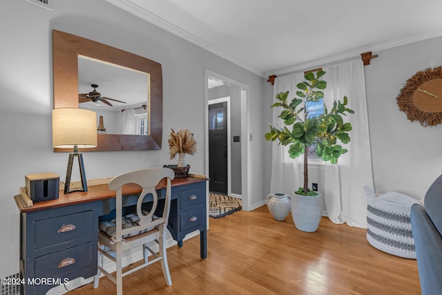 office featuring ceiling fan, crown molding, and light hardwood / wood-style floors