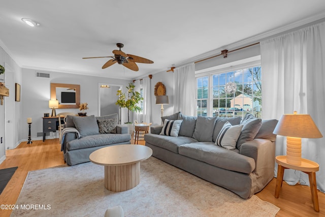 living room featuring ceiling fan, light hardwood / wood-style floors, and ornamental molding