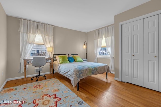 bedroom featuring light wood-type flooring and a closet