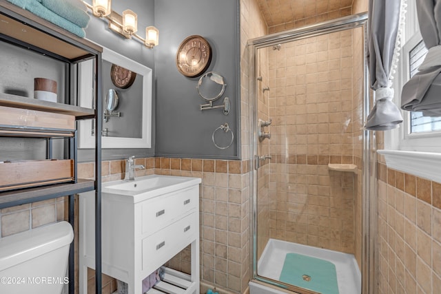 bathroom featuring an enclosed shower, toilet, and tile walls