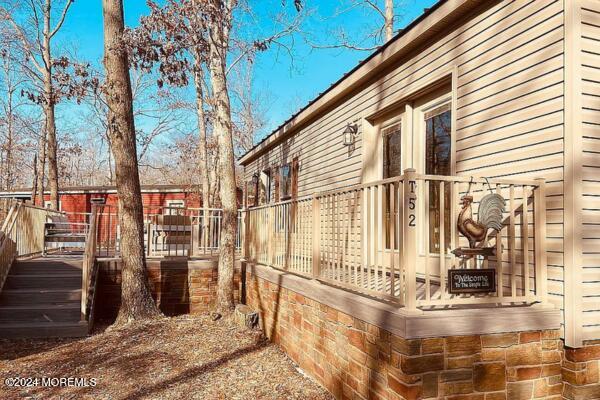 view of side of property featuring a wooden deck