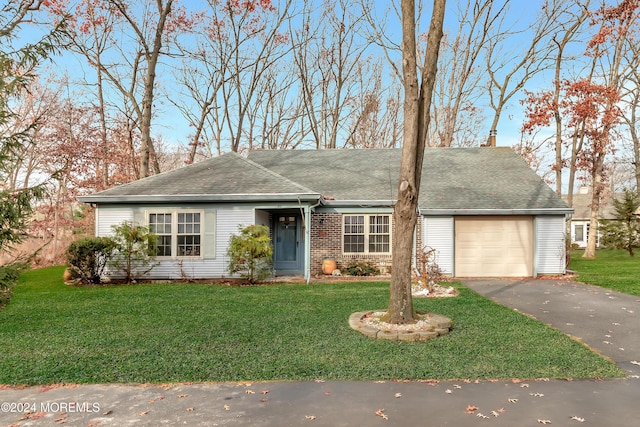 ranch-style home with a front yard and a garage