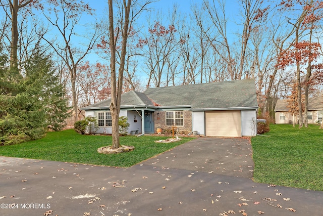 ranch-style house with a garage and a front yard