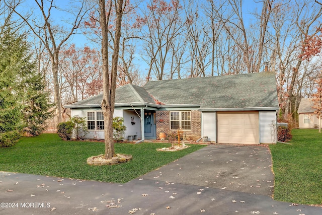 ranch-style home with a garage and a front lawn