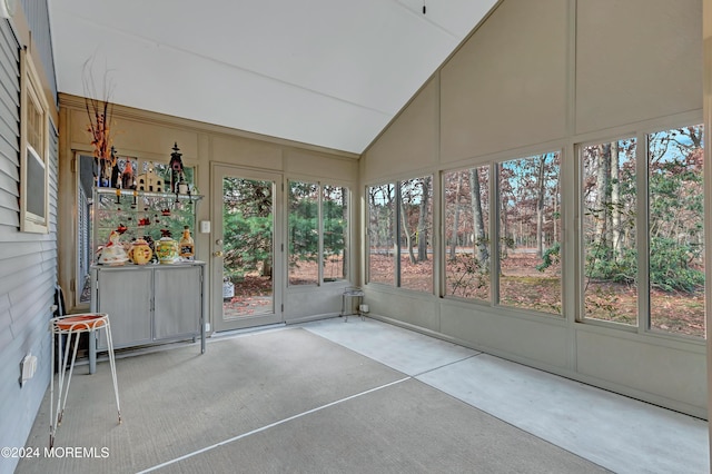 unfurnished sunroom featuring lofted ceiling