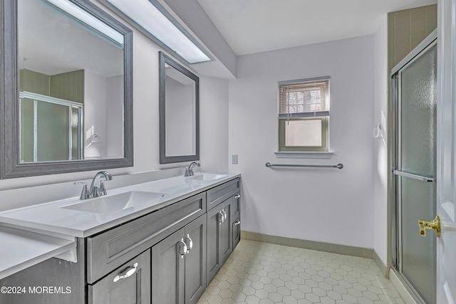 bathroom featuring tile patterned floors, vanity, and a shower with shower door