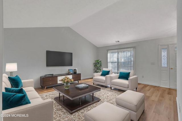 living room featuring light hardwood / wood-style floors and lofted ceiling