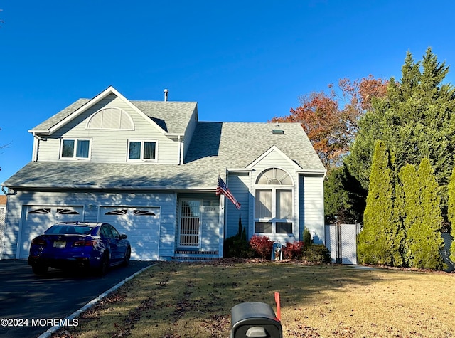 view of front of home with a front lawn and a garage