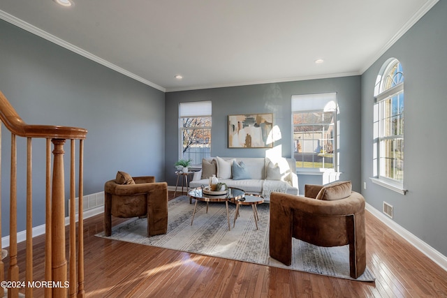 living room featuring light wood-type flooring and ornamental molding