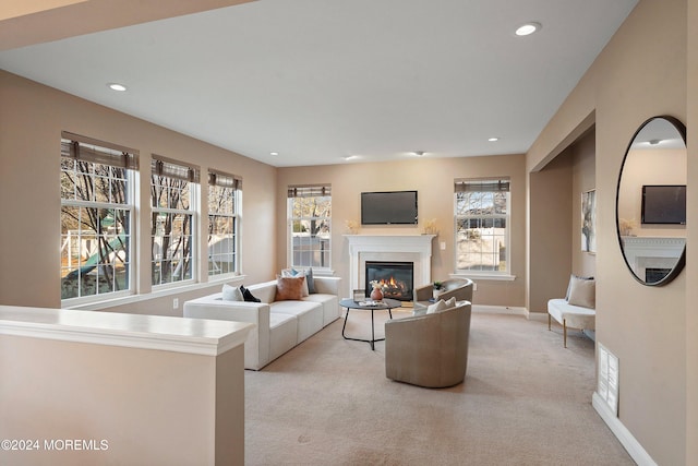 living room with light colored carpet and plenty of natural light