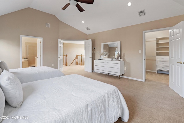 bedroom with lofted ceiling, ensuite bathroom, ceiling fan, a spacious closet, and light colored carpet