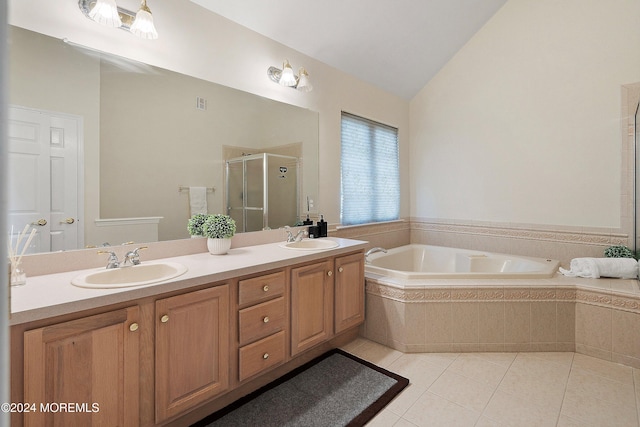 bathroom with tile patterned floors, vanity, independent shower and bath, and vaulted ceiling