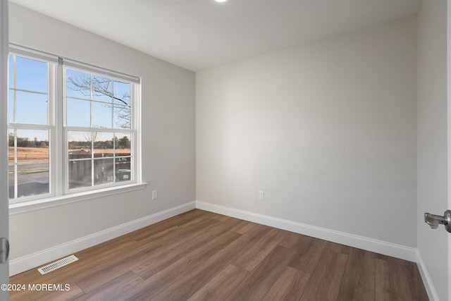 empty room with hardwood / wood-style flooring