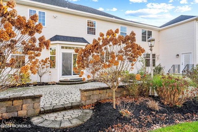 back of house with a patio