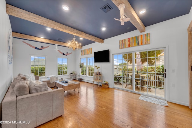 living room featuring ceiling fan with notable chandelier, beam ceiling, and light hardwood / wood-style flooring