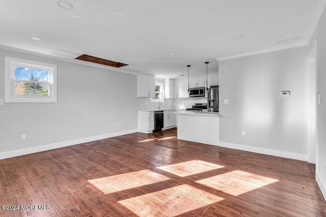 unfurnished living room with sink, ornamental molding, and dark wood-type flooring