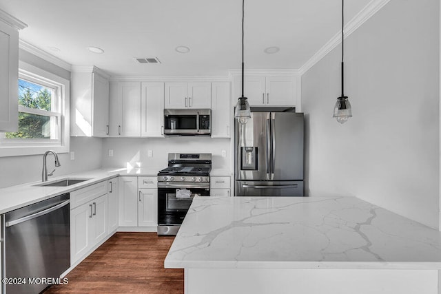 kitchen with pendant lighting, stainless steel appliances, and white cabinetry