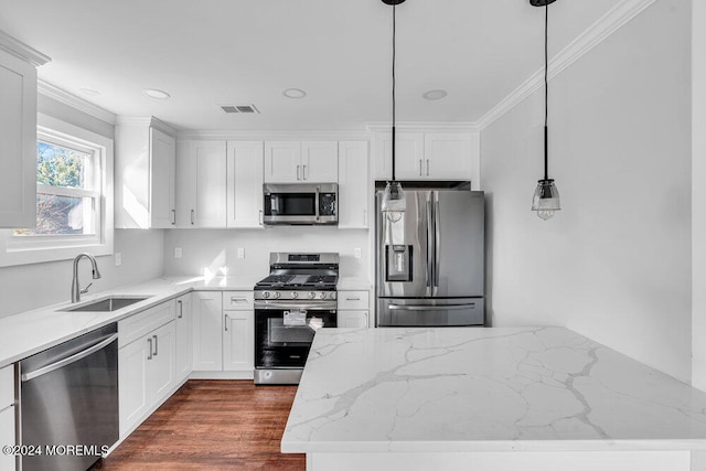 kitchen featuring pendant lighting, sink, white cabinetry, and stainless steel appliances