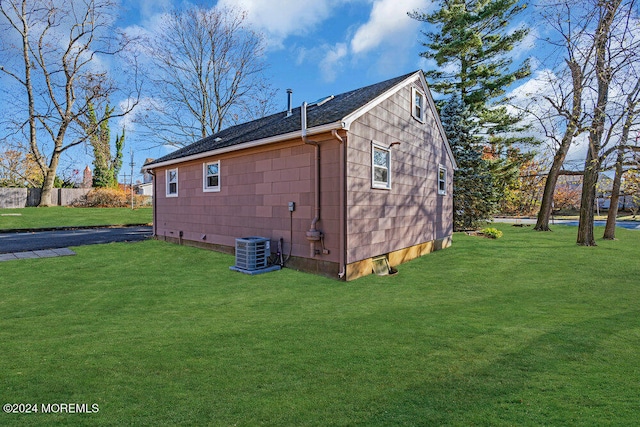 view of home's exterior with a lawn and cooling unit