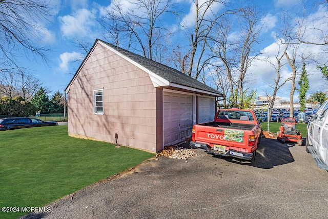 garage featuring a yard