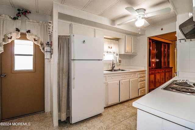 kitchen featuring white cabinetry, sink, ceiling fan, and white refrigerator