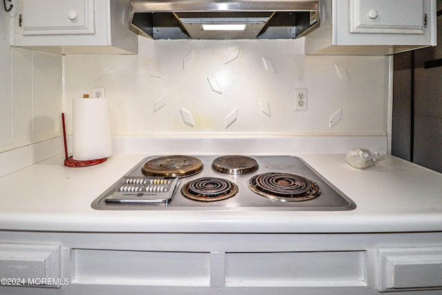 room details featuring stainless steel cooktop and exhaust hood