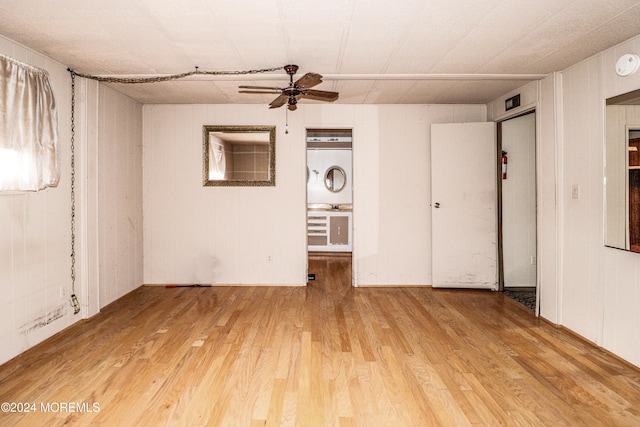 empty room with hardwood / wood-style floors and ceiling fan