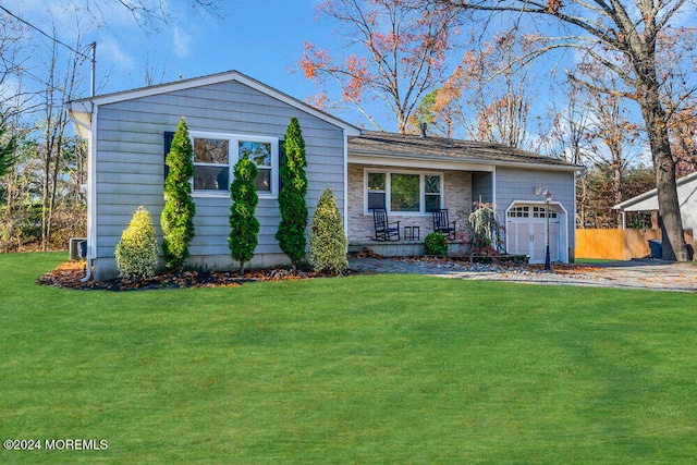 ranch-style home featuring a front yard and a garage