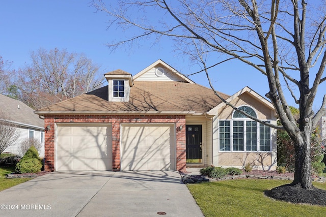 view of front facade with a garage and a front lawn