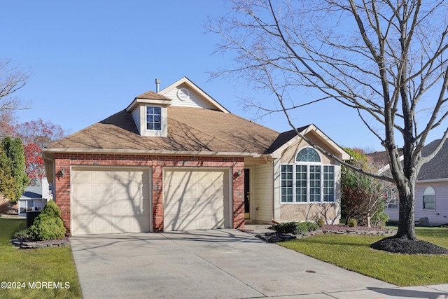 view of front facade with a front yard and a garage