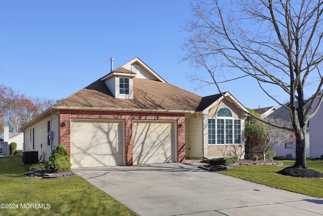 view of front facade with central AC, a front yard, and a garage