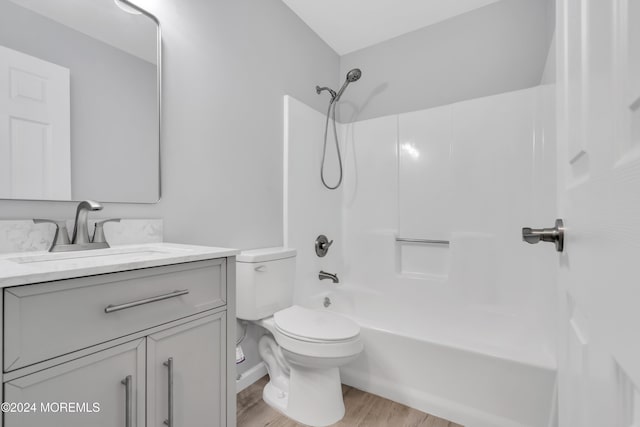 full bathroom with wood-type flooring, vanity, toilet, and shower / washtub combination